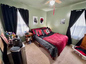 Bedroom featuring ceiling fan and carpet flooring