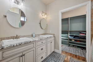 Bathroom with hardwood / wood-style flooring and vanity