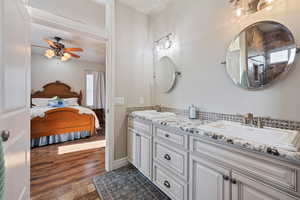 Bathroom featuring vanity, wood-type flooring, and ceiling fan