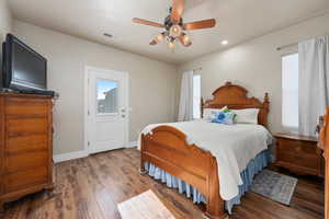 Bedroom featuring dark hardwood / wood-style flooring and ceiling fan