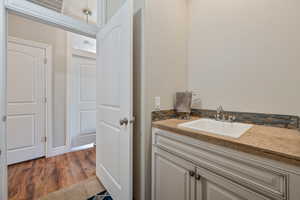 Bathroom with vanity and hardwood / wood-style flooring