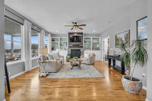 Living room connected to informal dining, kitchen, deck, and office