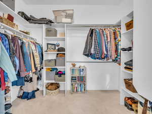 Primary bedroom walk in closet