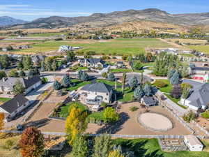 Birds eye view of property featuring a paddock, greenhouse, sheds, hot tub, deck, and green space