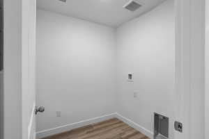 Laundry area featuring washer hookup and hardwood / wood-style floors