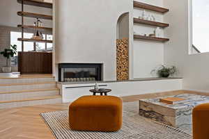 Living room featuring plenty of natural light and a multi sided fireplace