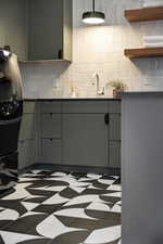 Kitchen featuring sink and backsplash