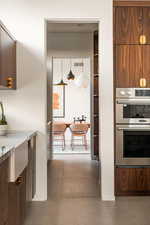 Kitchen with decorative light fixtures and stainless steel double oven