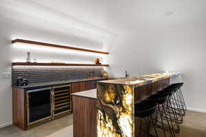 Bar featuring light carpet and wine cooler