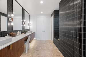 Bathroom featuring vanity and tile walls