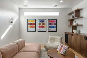 Living room with light hardwood / wood-style floors