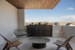 View of patio / terrace with a mountain view and an outdoor fire pit