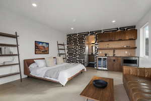 Bedroom with wine cooler and bar