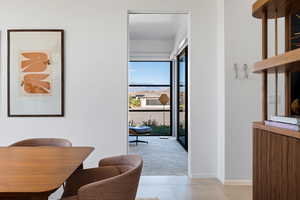 Dining space with light tile patterned floors