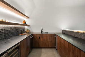 Bar with tasteful backsplash, sink, beverage cooler, and dishwasher