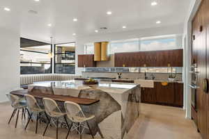 Kitchen with tasteful backsplash, sink, a breakfast bar area, a center island, and stainless steel appliances