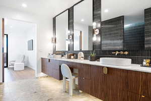 Bathroom with vanity and backsplash