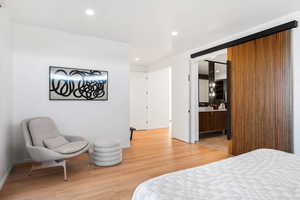 Bedroom featuring connected bathroom and light hardwood / wood-style floors