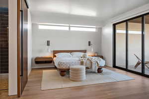 Bedroom featuring access to exterior and light hardwood / wood-style floors