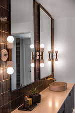 Bathroom featuring sink and decorative backsplash