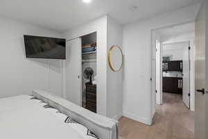 Bedroom with a closet and light hardwood / wood-style flooring