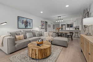 Living room with light hardwood / wood-style flooring