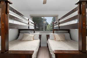 Bedroom with ceiling fan and dark hardwood / wood-style flooring