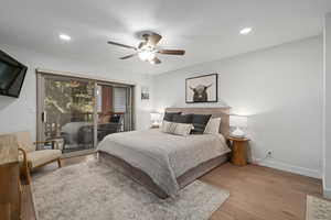 Bedroom featuring ceiling fan, access to outside, and light hardwood / wood-style floors