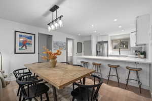 Dining area featuring sink and light hardwood / wood-style flooring