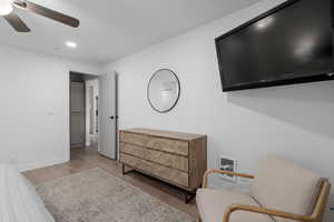 Bedroom with ceiling fan and light wood-type flooring