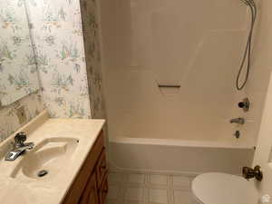 Full bathroom with vanity, bathing tub / shower combination, and toilet