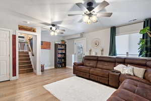 Living room with ceiling fan, a healthy amount of sunlight, and light hardwood / wood-style floors