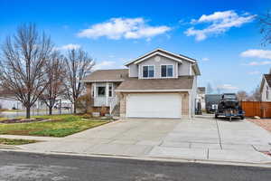 View of front of house featuring a garage and a front lawn