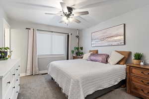 Carpeted bedroom featuring ceiling fan