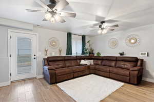 Living room featuring ceiling fan and light wood-type flooring