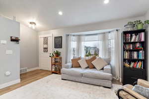 Living room with light hardwood / wood-style flooring