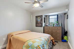 Bedroom with ceiling fan and carpet