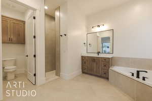 Full bathroom featuring vanity, toilet, tile patterned flooring, and shower with separate bathtub