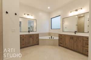 Bathroom with vanity and a relaxing tiled tub