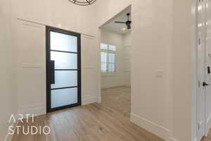 Entrance foyer featuring ceiling fan and light hardwood / wood-style flooring