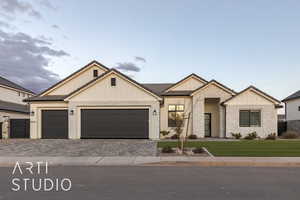 View of front of house with a garage and a front yard