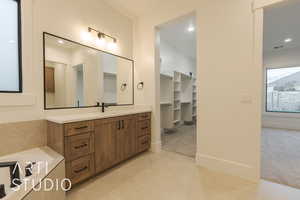 Bathroom featuring tile patterned flooring and vanity