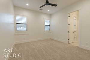 Unfurnished room with a wealth of natural light, light carpet, and ceiling fan