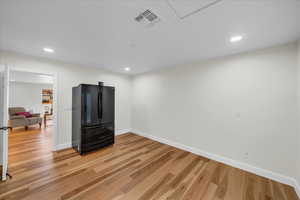 Interior space featuring black refrigerator and hardwood / wood-style floors