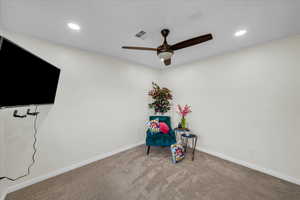 Unfurnished room with ceiling fan and light carpet