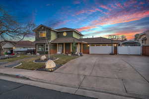 View of front of home featuring a garage and a yard