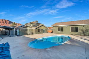 View of swimming pool featuring a mountain view, central AC, and a patio area