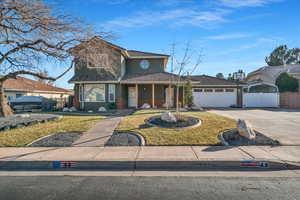 View of property with a garage and a front yard