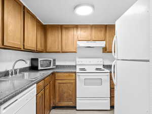 Kitchen with sink and white appliances