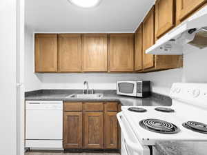 Kitchen with sink and white appliances